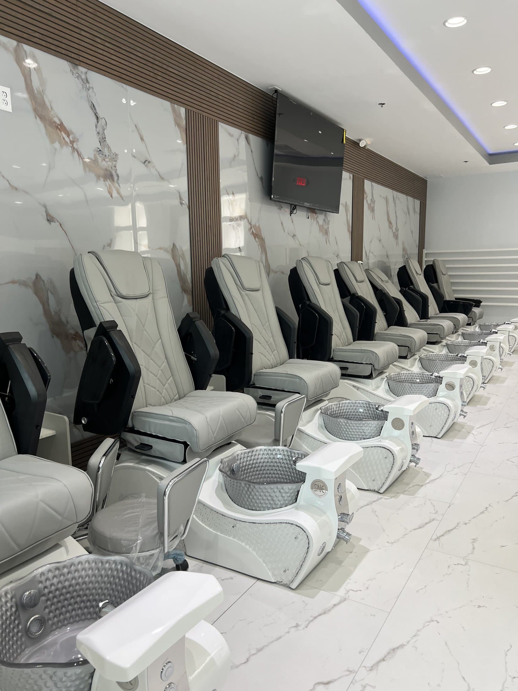 Row of massage pedicure chairs at Blue Nails & Spa in Tallahassee, FL