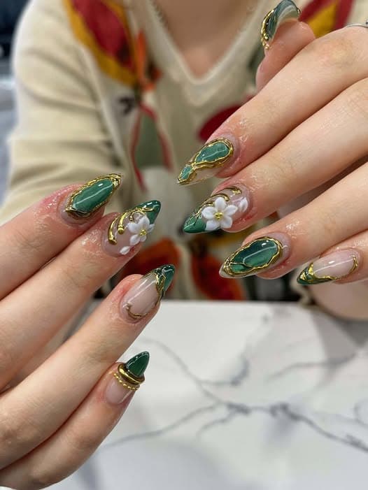 Green and gold 3D floral nail art with white flowers by Blue Nails & Spa, Tallahassee, FL