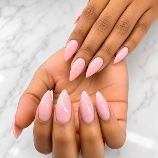 Glossy solid pink stiletto nails by Blue Nails & Spa, Tallahassee, FL